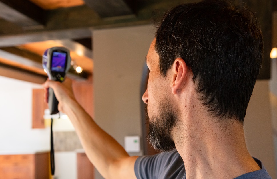 a consultant scanning a room as part of an air quality assessment