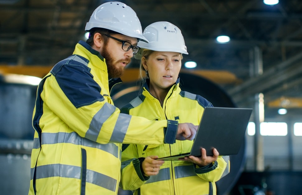 A consultant explaining the information in a construction environmental management plan to an architect