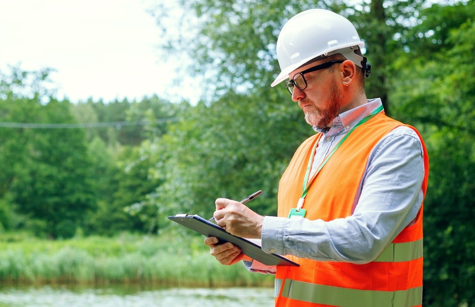A consultant taking down notes as part of a flood risk assessment