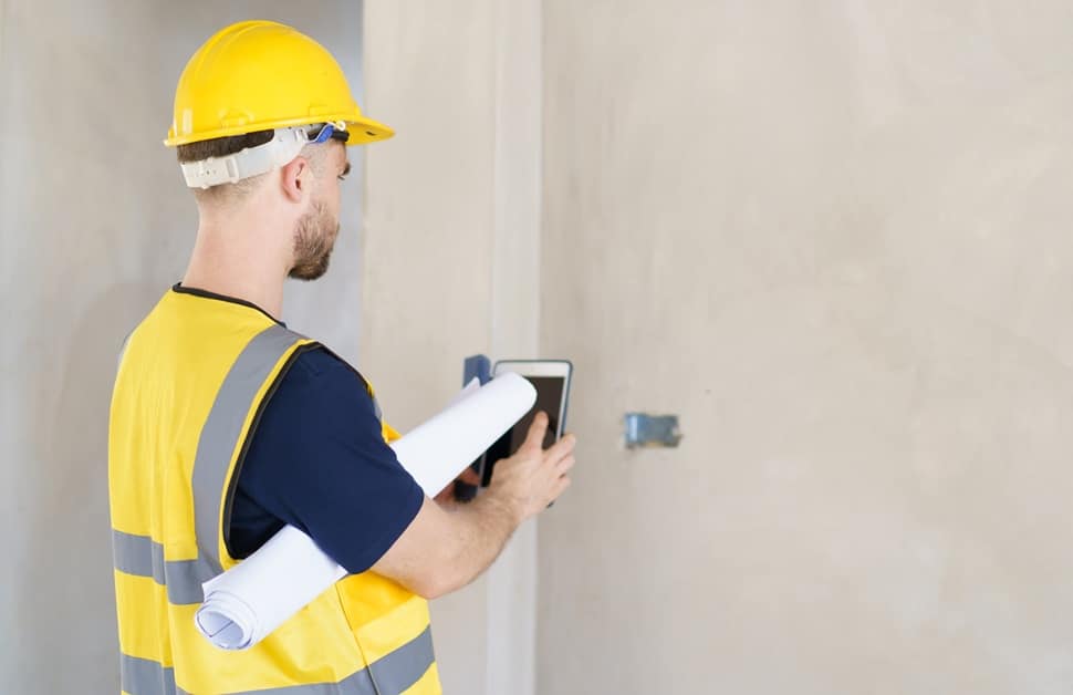 A building surveyor carrying out a condition report within a property