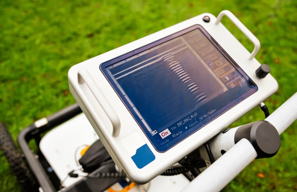 A ground penetrating radar midway through scanning beneath the ground, as part of utility mapping