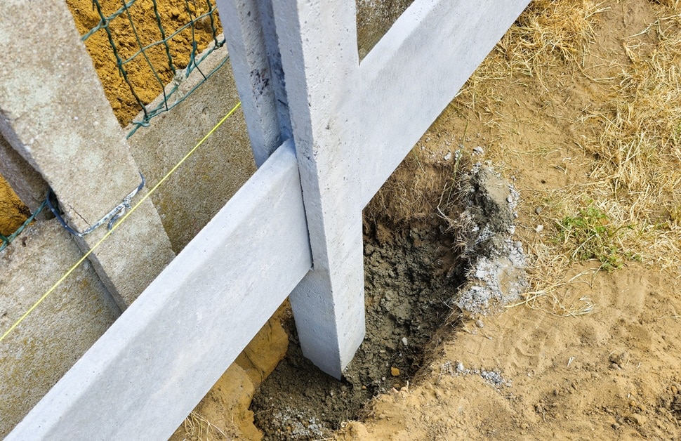 a fence being built on the very edge of the boundary line